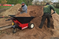 Electric powered Wheelbarrow being loaded with sand