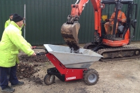 MUV - Electric Wheelbarrow being loaded by mini digger