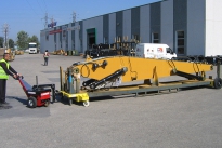 Power Pusher with Steering Arm moving excavator boom on mobile stillage